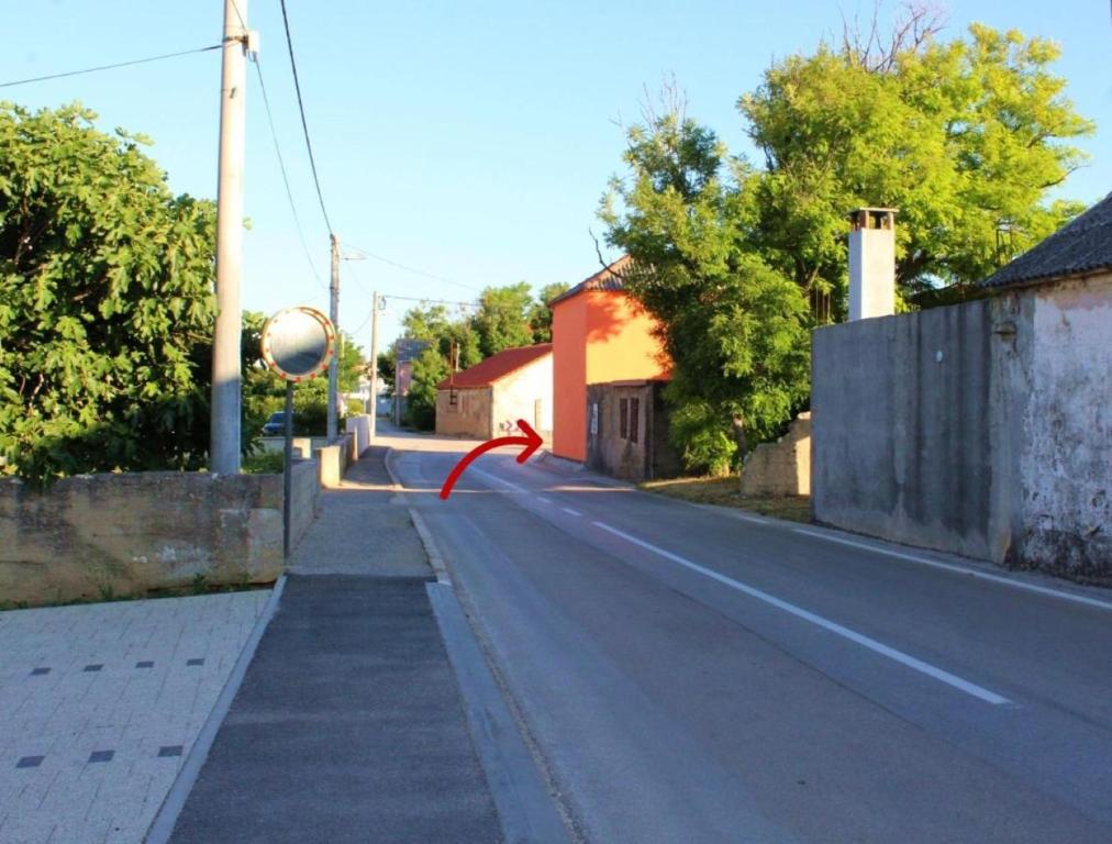 an empty street with a red ribbon on the road at Holiday home Ivana - private pool in Privlaka
