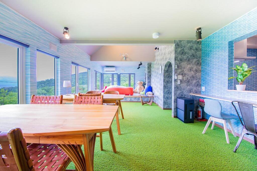 a living room with a wooden table and chairs at The BASE in Otaru