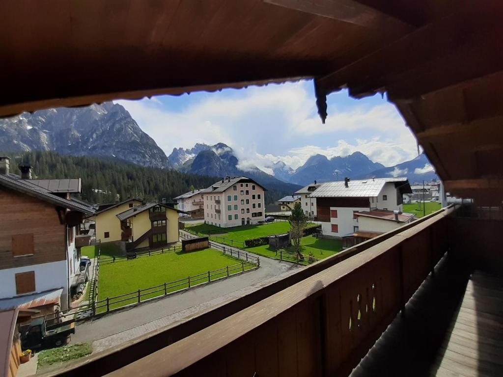 a view from a balcony of a town with mountains at Appartamenti Soravia in Sappada