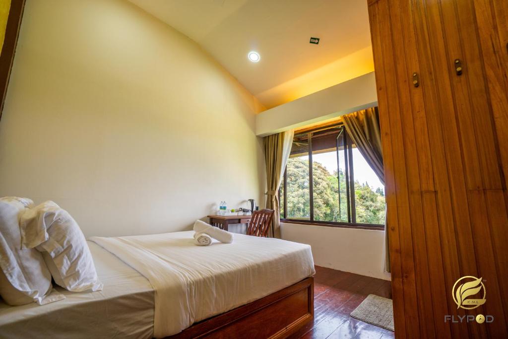 Postel nebo postele na pokoji v ubytování Flypod . Kinabalu Mt Lodge