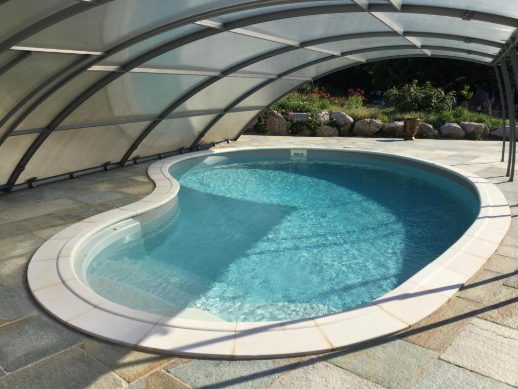 an overhead view of a swimming pool in a dome tent at Appartement les Ecureuils in La Roque-dʼAnthéron