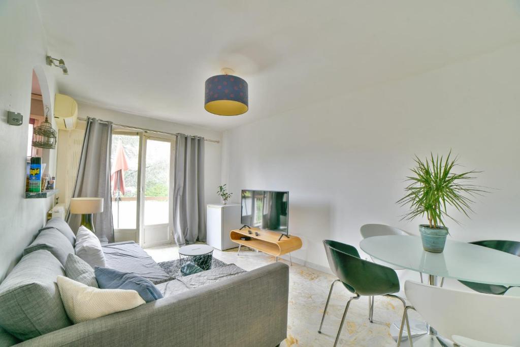 un salon avec un canapé et une table dans l'établissement Charmant 47 m au calme, à Nice