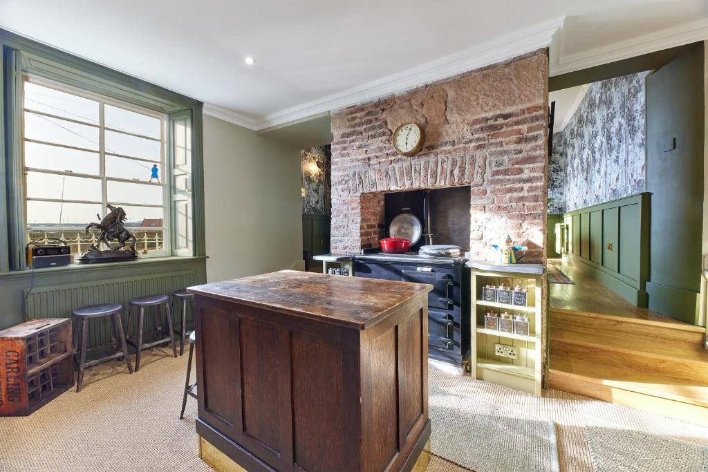 a kitchen with a counter and a brick wall at River View: Characterful Townhouse, Stunning Views in Berwick-Upon-Tweed