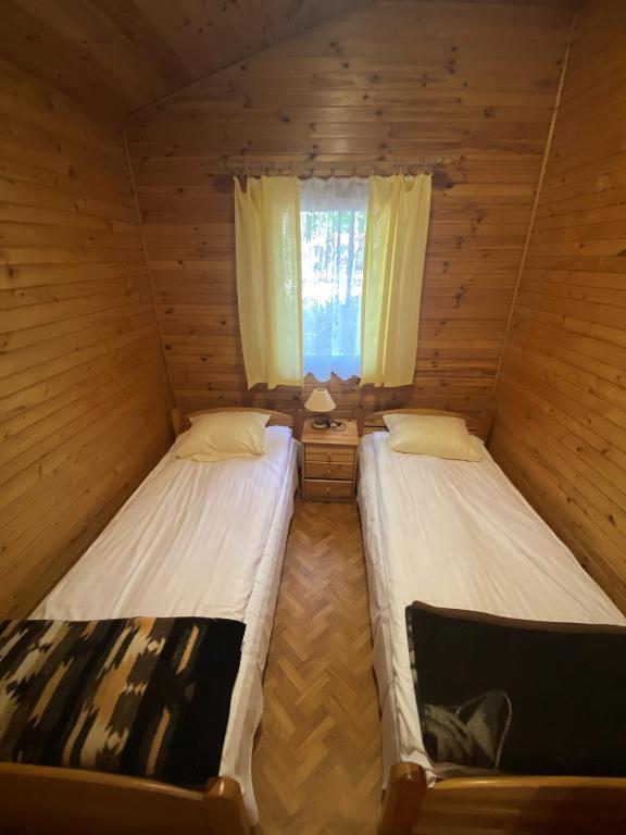 Postel nebo postele na pokoji v ubytování Ośrodek Wrzosowa Góra - domki