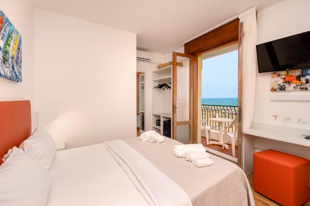 En eller flere senger på et rom på Hotel Royal Garnì
