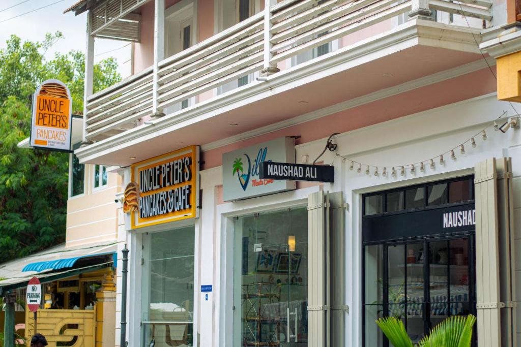 a store with signs on the side of a building at Villa Montecarlo in Pondicherry