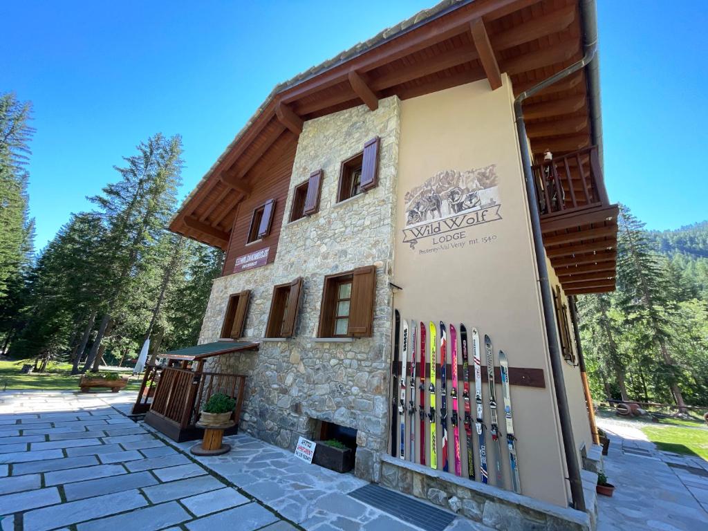 a building with a bunch of skis on the side at WILDHOMES Wild Wolf Lodge in Courmayeur