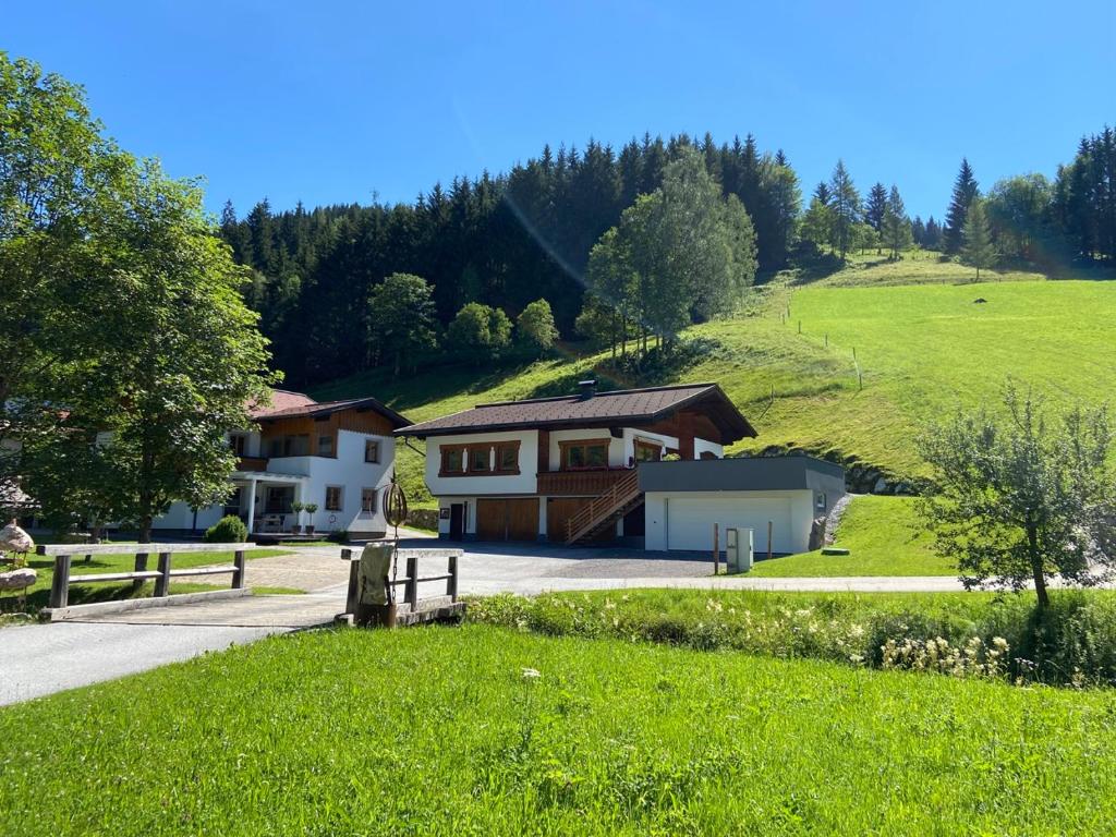 a house in the middle of a green hill at Landhaus Weiss in Sankt Martin am Tennengebirge