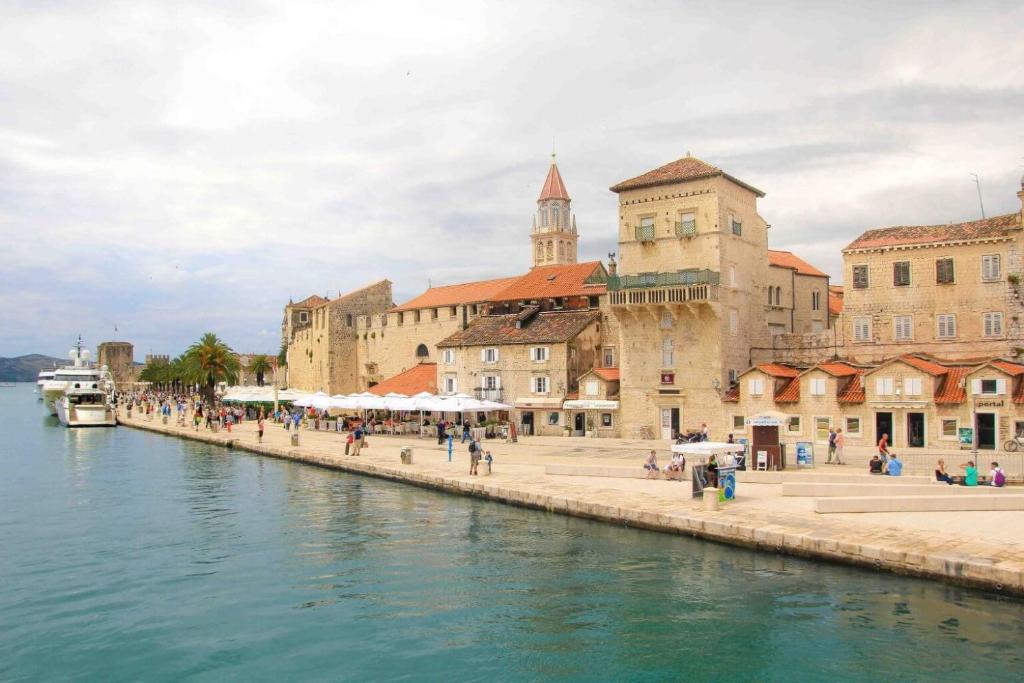a group of buildings next to a body of water at Lux Trogir in Trogir