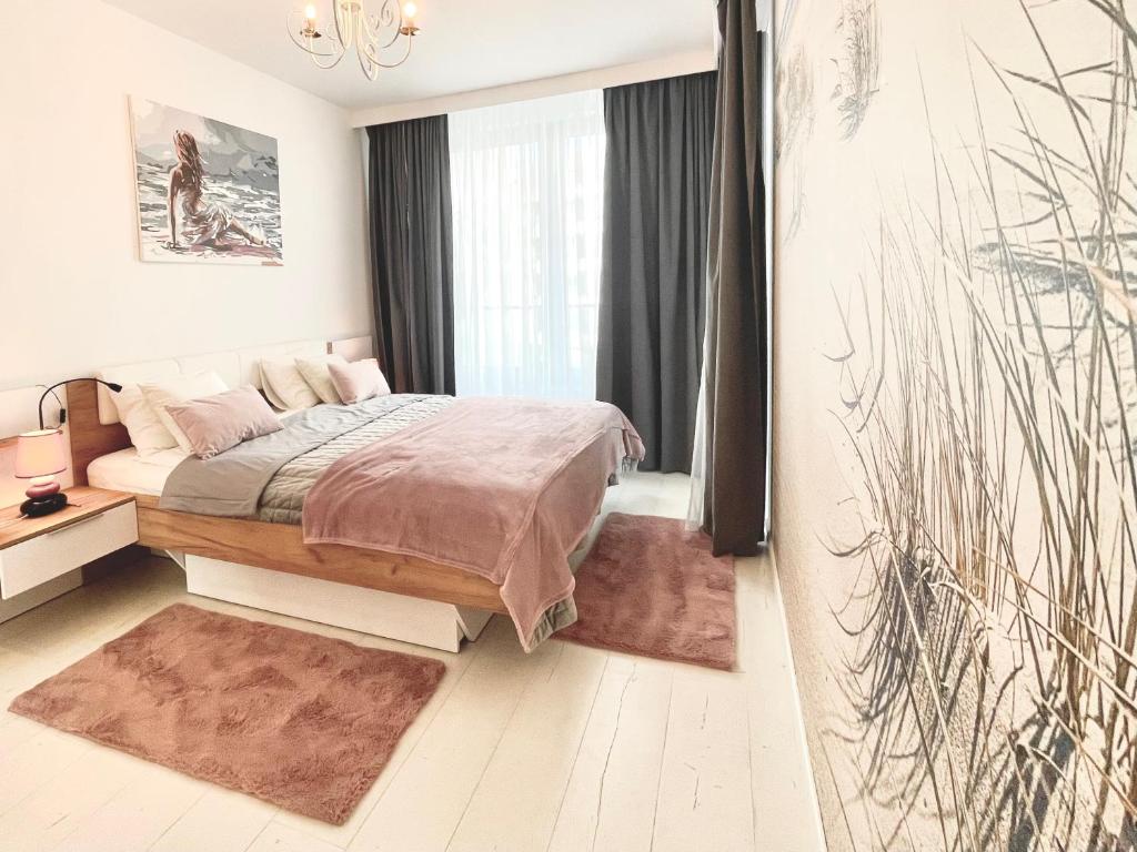 a bedroom with a bed and a large window at Apartament Nadmorski - Plac Unii - Parking in Gdynia