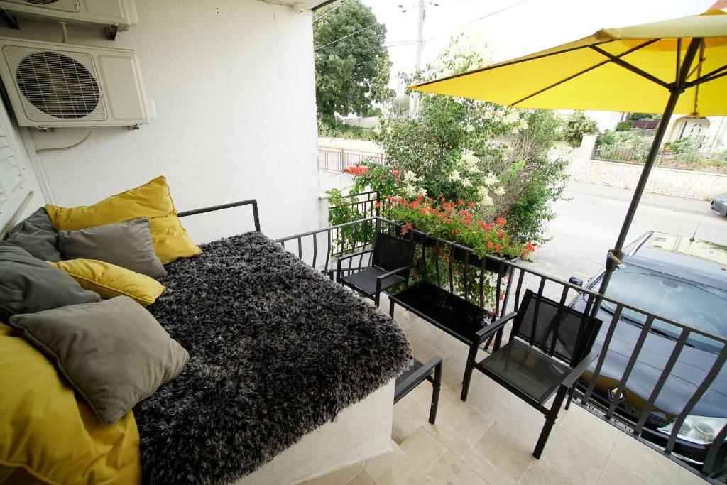 - Balcón con sofá y sombrilla en A&N Zadar, en Zadar