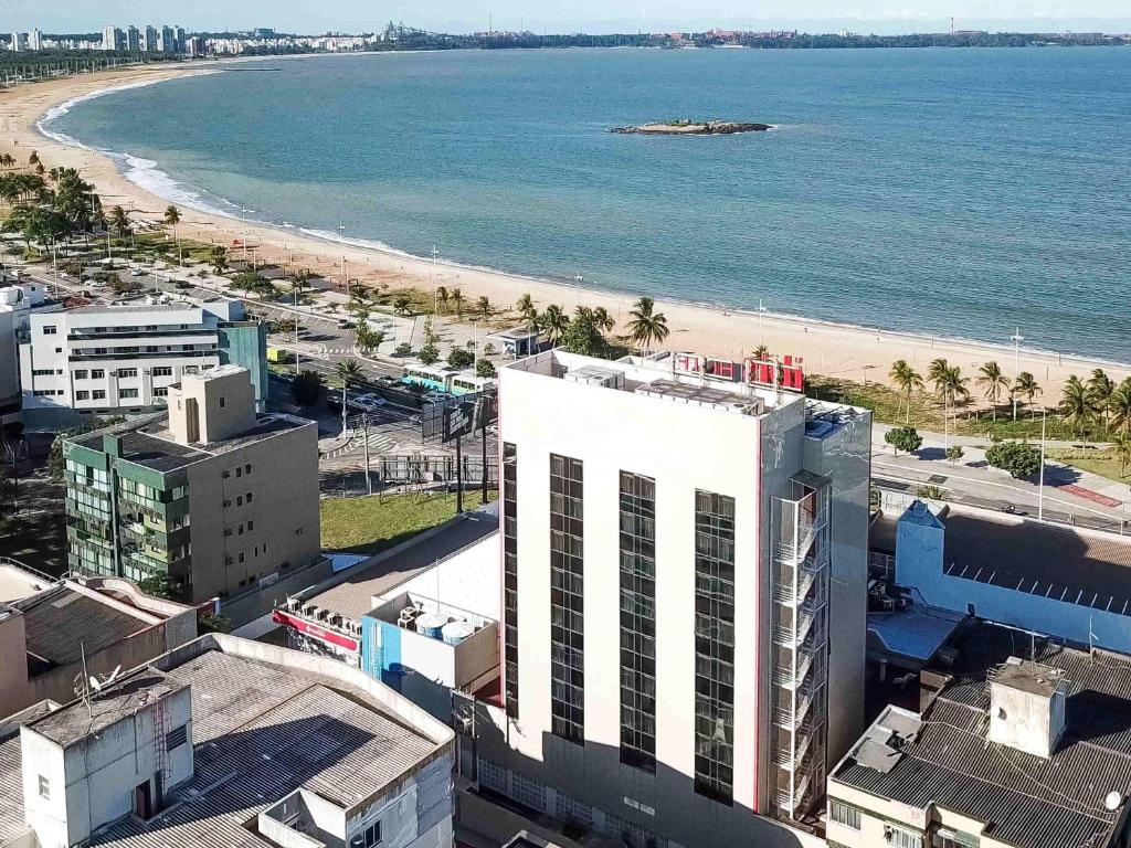 an aerial view of a beach and a building at ibis Vitoria Praia de Camburi in Vitória