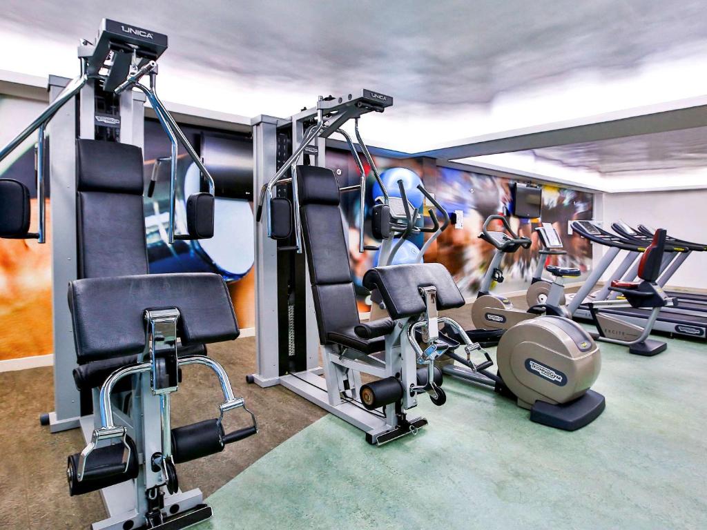 a gym with several tread machines in a room at Novotel RJ Santos Dumont in Rio de Janeiro
