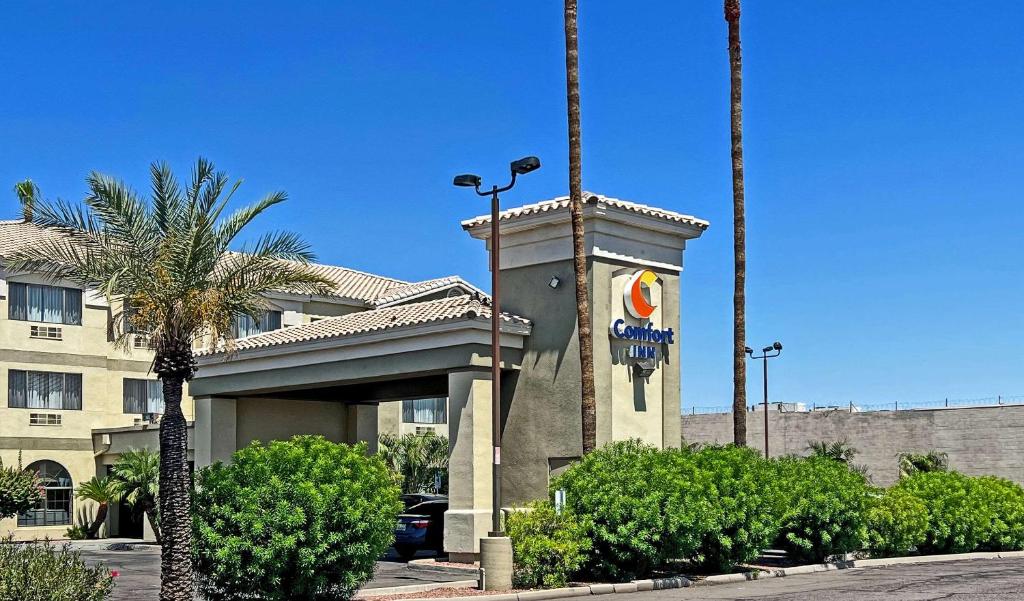 a hotel with a clock tower in front of a building at Comfort Inn West Phoenix at 27th Ave and I-I0 in Phoenix