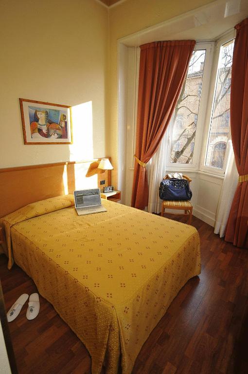 Postel nebo postele na pokoji v ubytování Hotel Estense