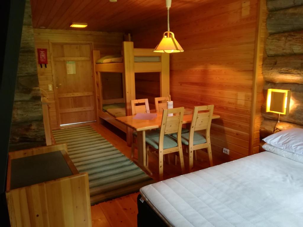 a bedroom with a bed and a table and chairs at Kelo Seasons Spring in Luosto
