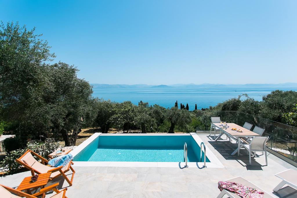 a swimming pool with a view of the ocean at oliva e mare luxury suite in Corfu Town
