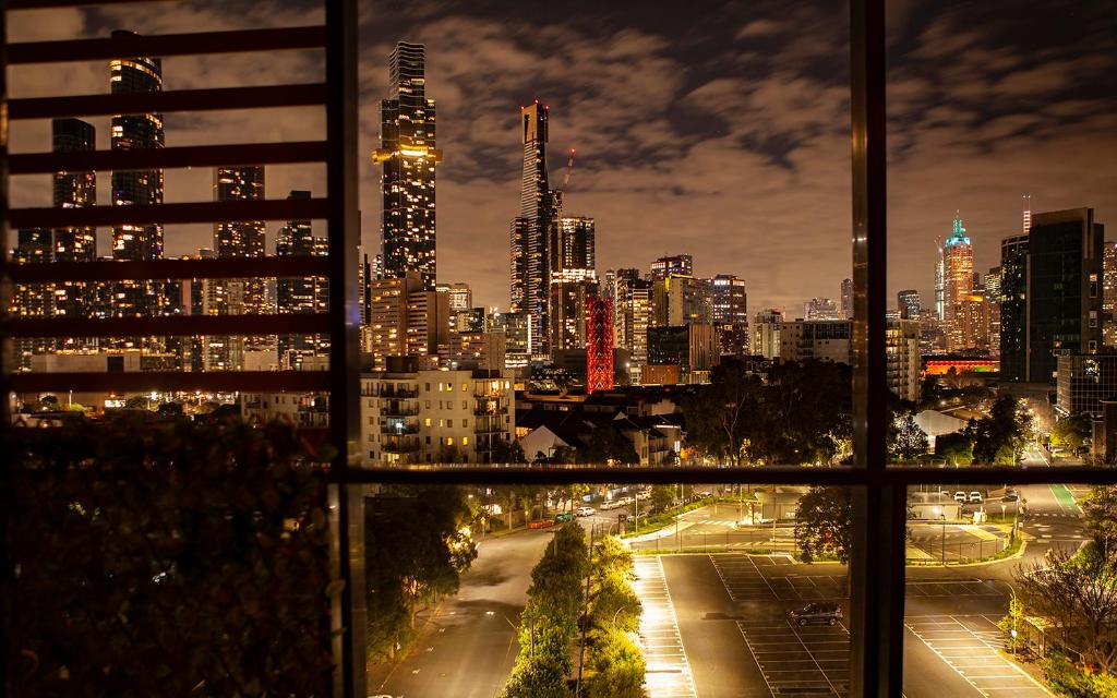 a view of a city at night from a window at Extraordinary holiday stay for Melbourne explore in Melbourne