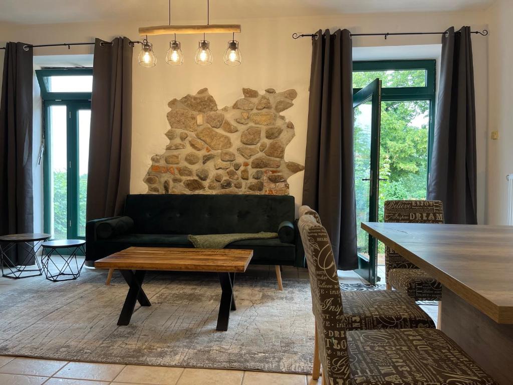 een woonkamer met een bank en een tafel bij Mitten in der Natur : Ferienwohnung mit 3 Schlafzimmern, neu eingerichtet in Neu Gaarz
