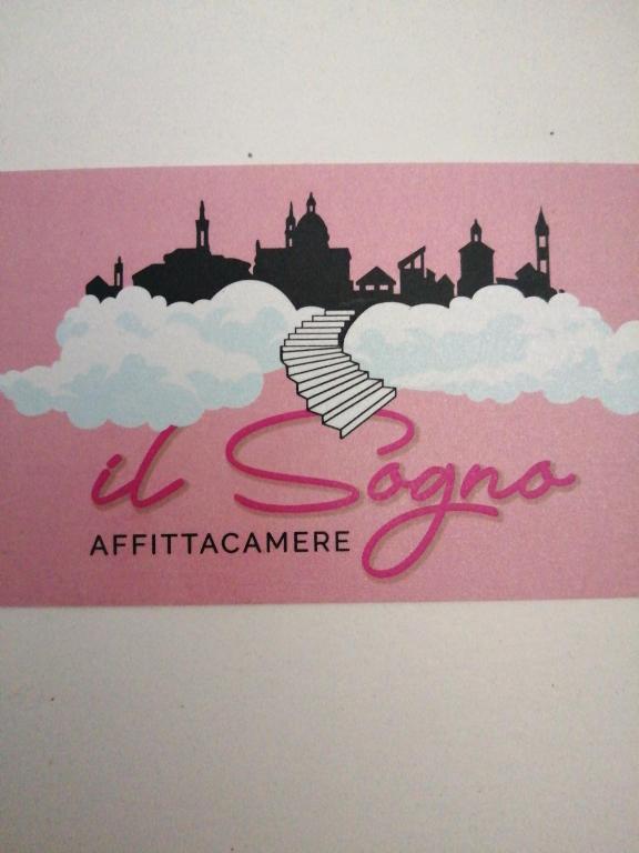 a pink sign with a city in the clouds at Il Sogno in Foligno