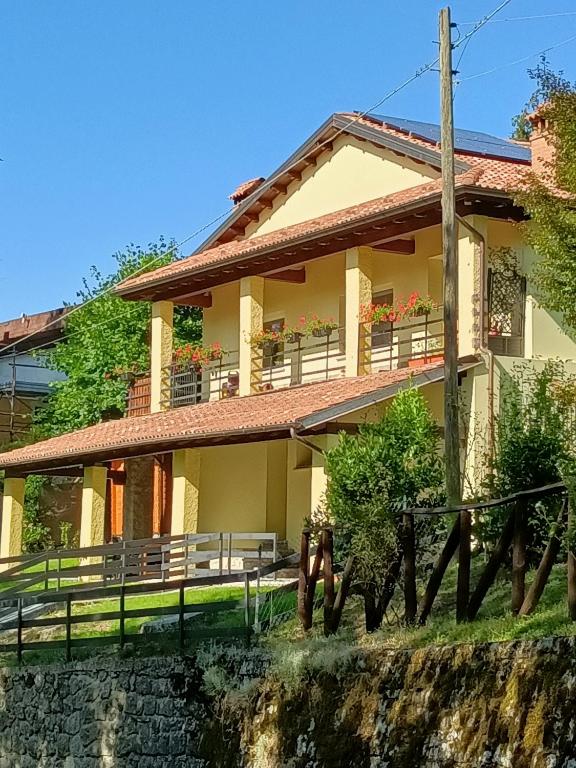 a house with a fence in front of it at B&B Il Ghiro in Riolunato