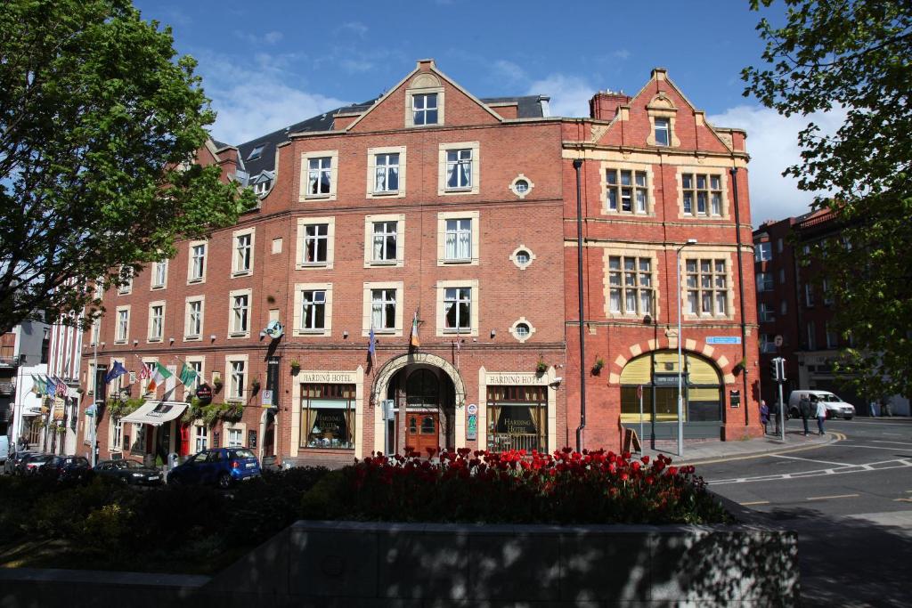 a large red brick building on a city street at Harding Hotel in Dublin
