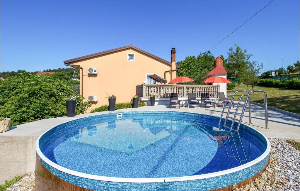 a swimming pool in front of a house at Amazing Apartment In Viskovo With Wifi in Viskovo