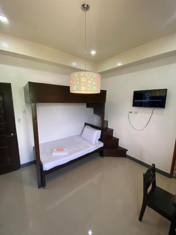 Postel nebo postele na pokoji v ubytování Ma Lourdes' Inn