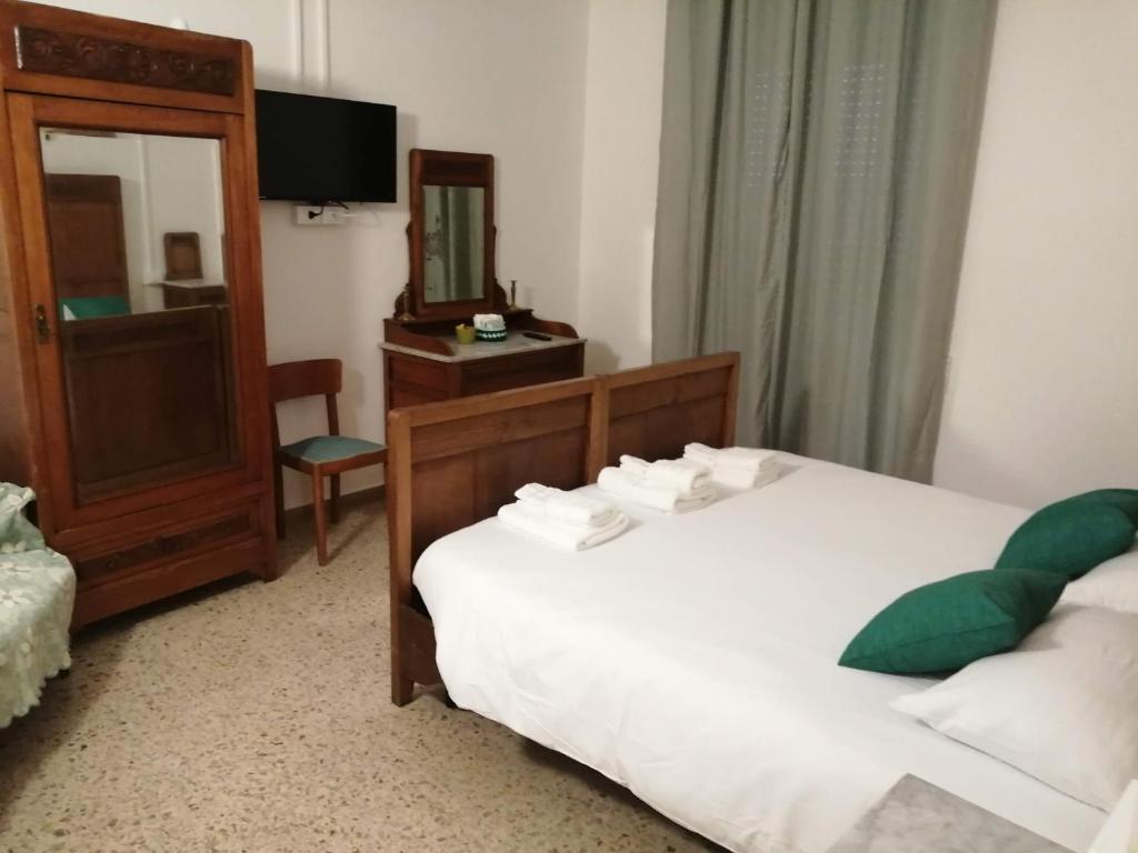 a hotel room with two beds and a mirror at Il Sogno in Foligno