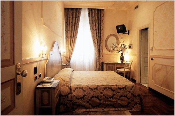 Uma cama ou camas num quarto em Hotel Aventino