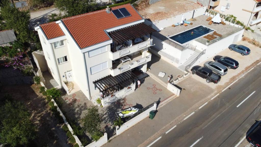 widok na biały dom z basenem w obiekcie Apartment Petra w mieście Starigrad-Paklenica