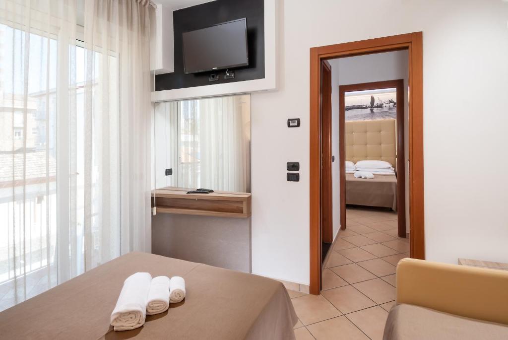 Postel nebo postele na pokoji v ubytování Hotel Lido