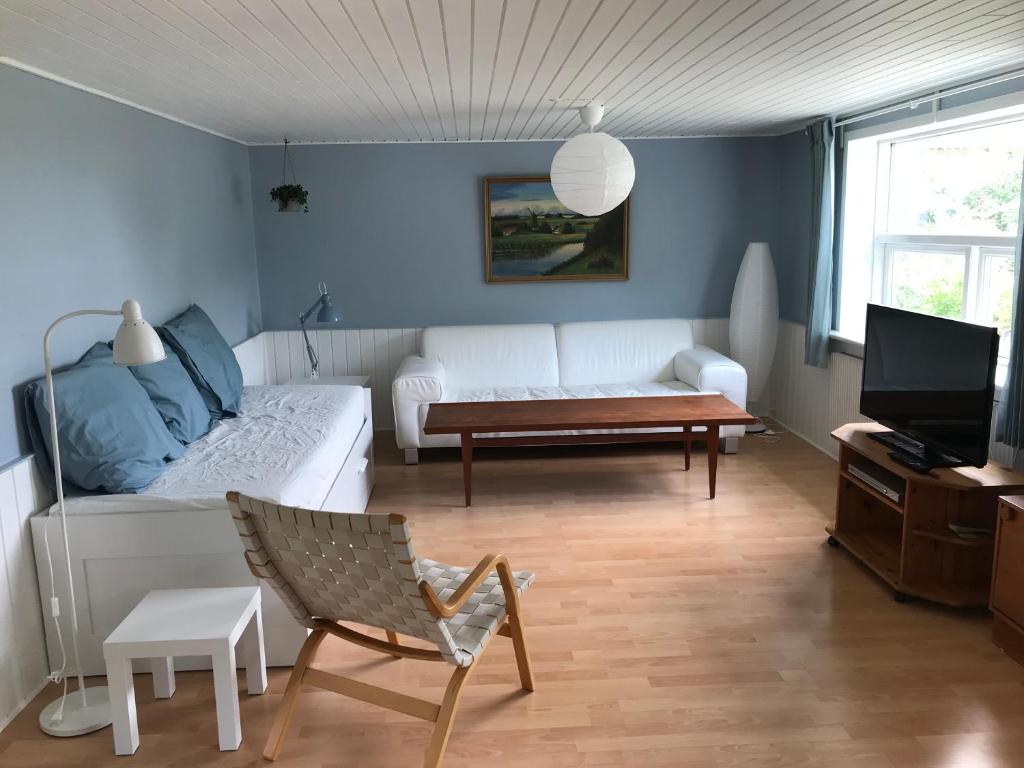 - un salon avec un canapé blanc et une table dans l'établissement Sommerhus på Mors, à Øster Assels