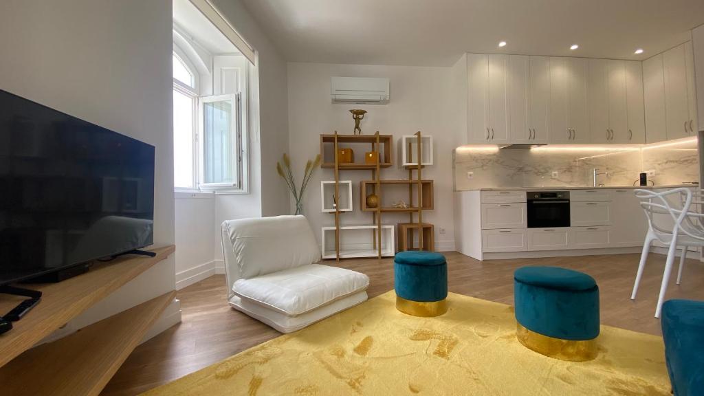 a living room with a tv and a kitchen at FERREIRA'S HOUSE Viana do Castelo in Viana do Castelo
