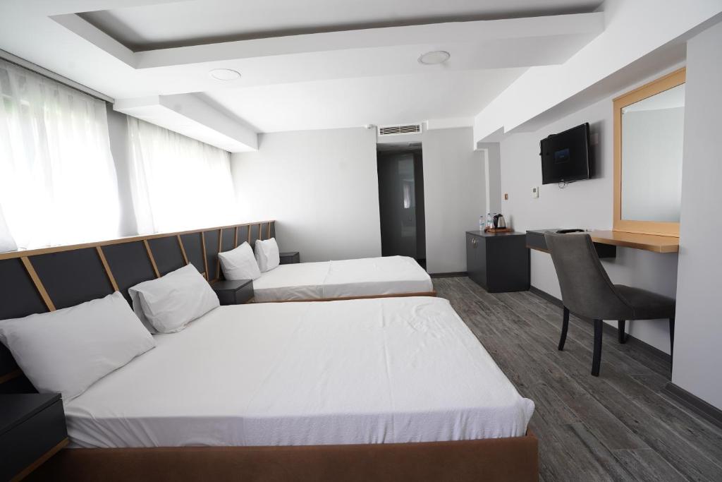A bed or beds in a room at Time Hotel Mecidiyekoy