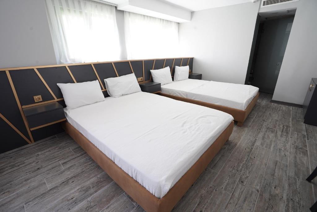 A bed or beds in a room at Time Hotel Mecidiyekoy