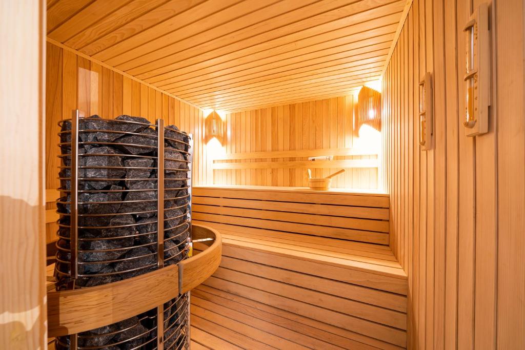 a sauna with wood paneling and a large stack of logs at Hotel Millennium by Aycon in Budva