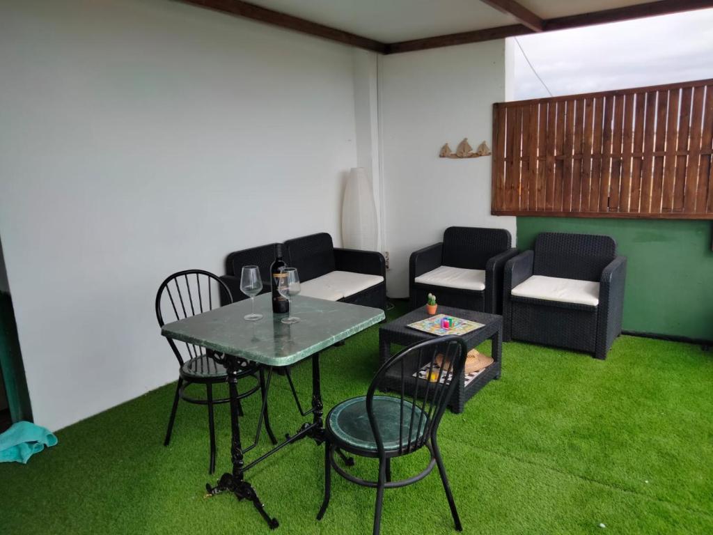 a living room with a table and chairs and a couch at Terraza Alcalá in Alcalá