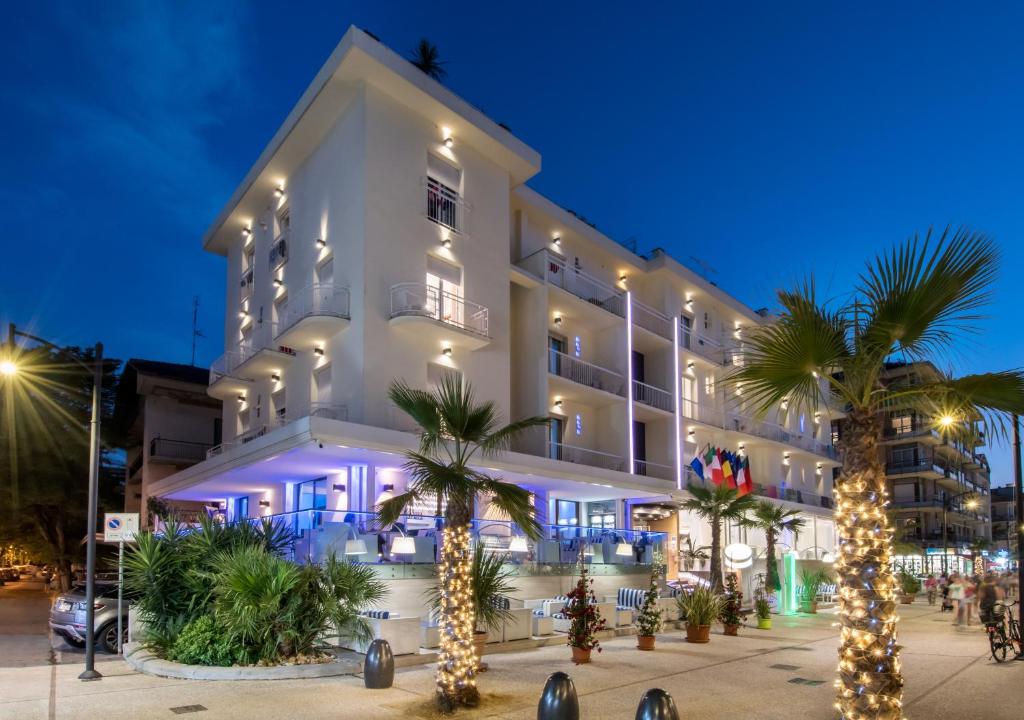 a hotel with christmas trees in front of it at Hotel Lido in Cattolica