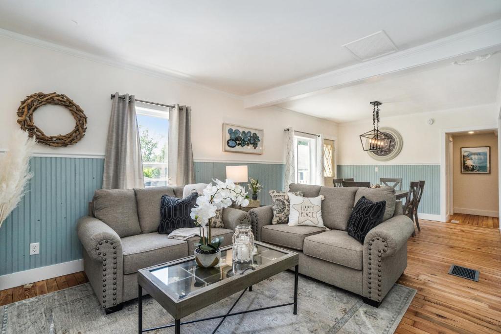 a living room with two couches and a table at The Wayfarer in South Haven