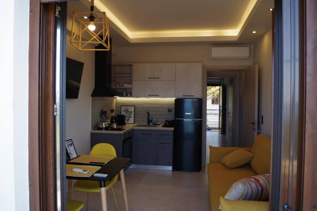 a kitchen and living room with a couch and a table at Seafront Centre Ouranoupoli in Ouranoupoli