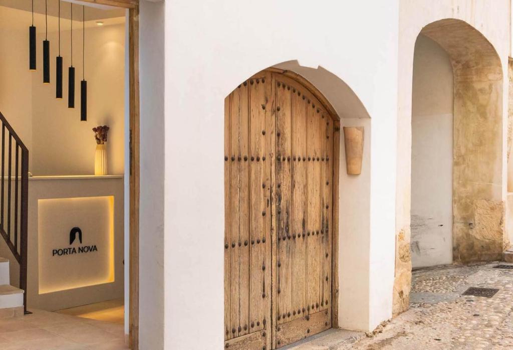 a wooden door on a wall in a store at Porta Nova Suites - Room Breakfast & Sea View in Altea