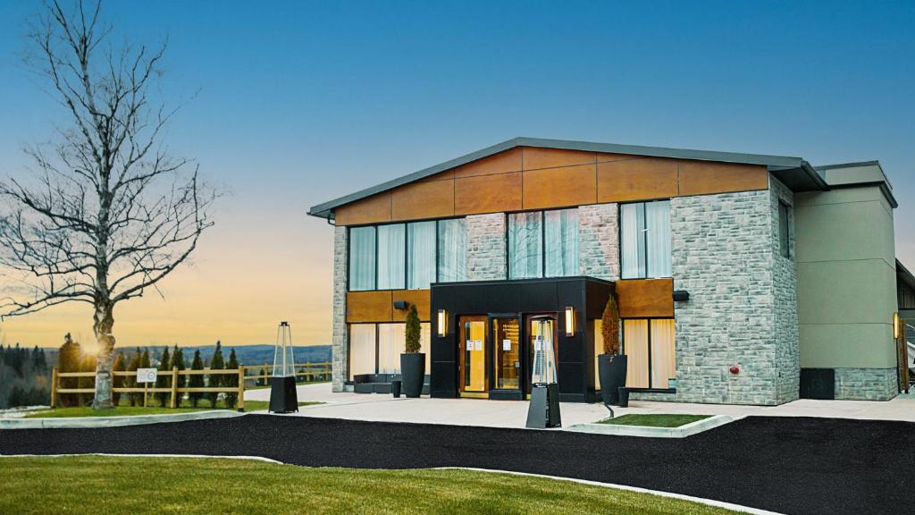 a large building with a tree in front of it at Mount Alverno Luxury Resorts in Caledon