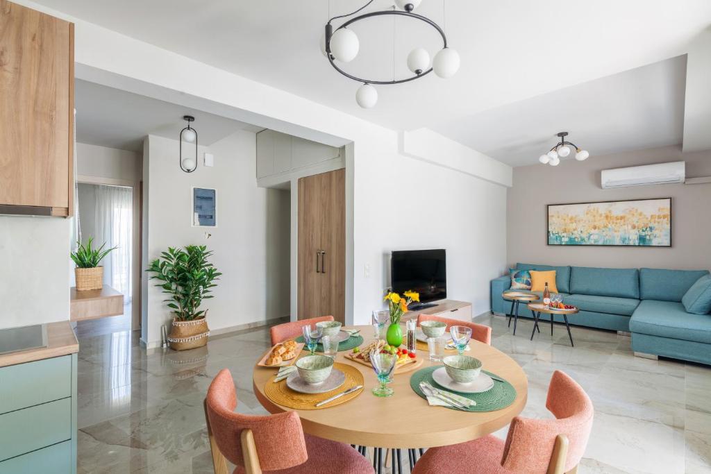 a kitchen and living room with a table and chairs at Design Central Suite in the heart of the city in Heraklio Town