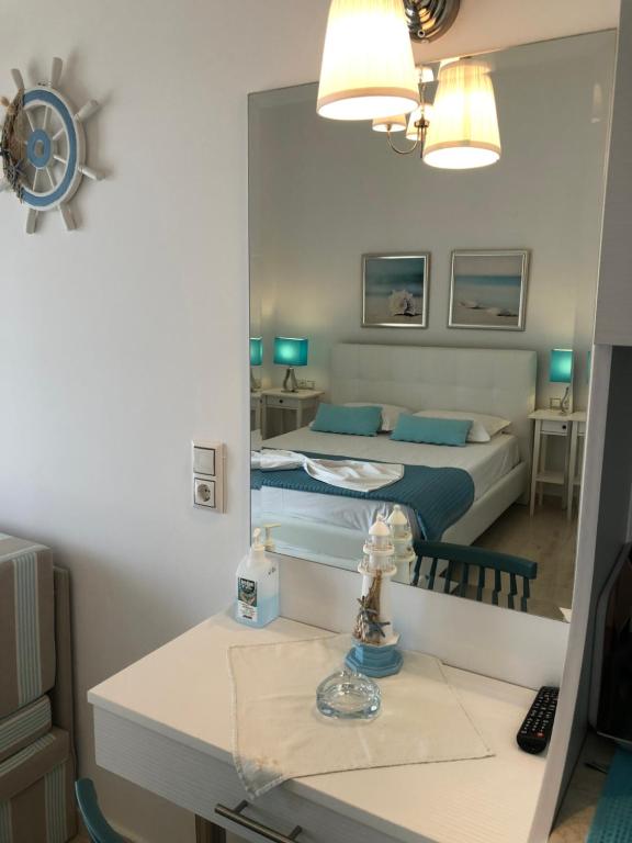 a bedroom with a bed and a mirror at Spyridonou House in Parga