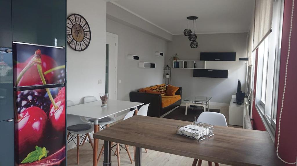 a living room with a table and a dining room at Foz Playas in Foz