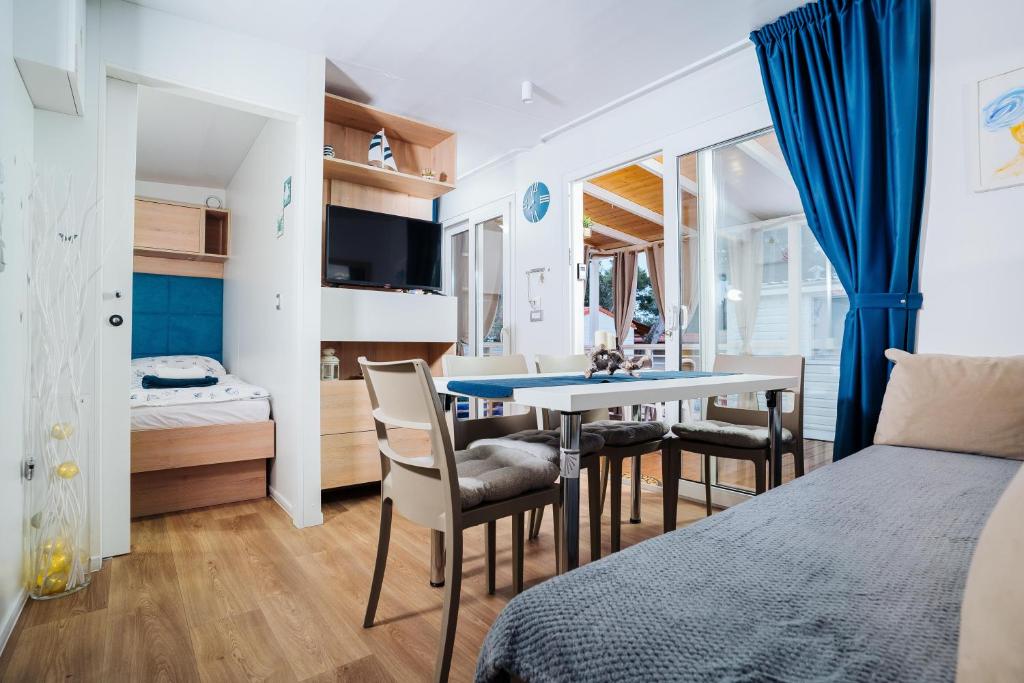 a bedroom with a bed and a table and chairs at Ehha Home in Biograd na Moru