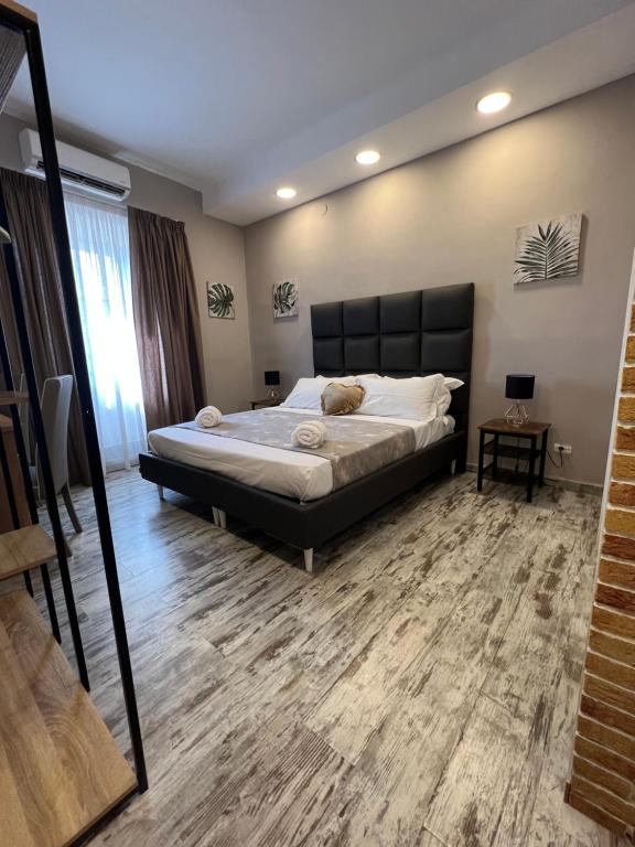 a bedroom with a large bed and a mirror at Dream & Fly in Naples