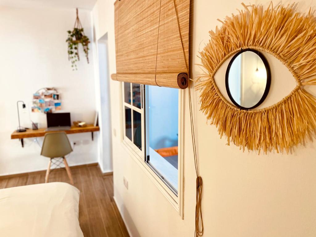 a mirror on a wall next to a bedroom at Casa Armonía in Morro del Jable