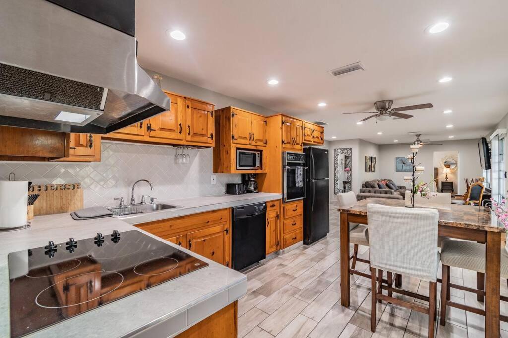 a kitchen with wooden cabinets and a counter top at Bay Breeze Retreat plus 15 minutes from central TPA in Tampa